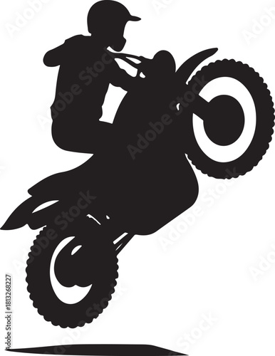 Black silhouette of a motocross rider performing a wheelie