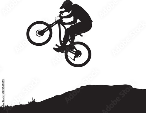 Black silhouette of a person on a mountain bike jumping over a hill