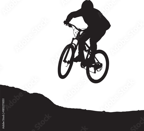 Black silhouette of a person on a mountain bike jumping