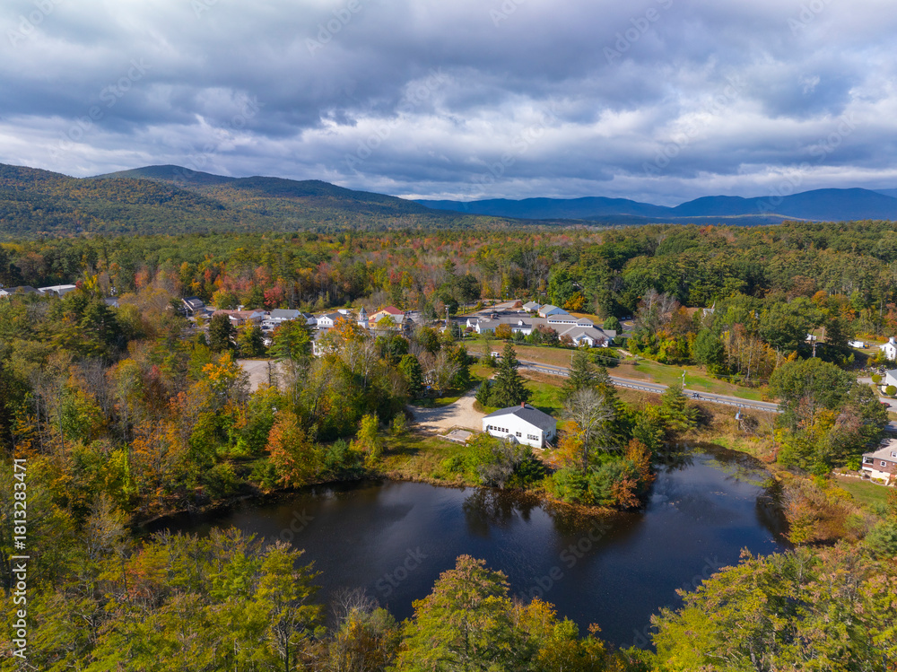 Fototapeta premium Moultonboro historic town center aerial view in fall with Red Hill at the background, Moultonboro, New Hampshire NH, USA. 