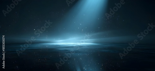 Beautiful ocean water surface glowing under dramatic blue light with sparkling reflections, deep sea fantasy background and mysterious underwater concept