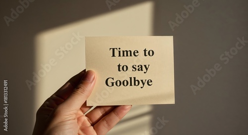 Farewell Message: A hand tenderly presents a card, the words Time to say Goodbye etched upon it, creating a moment of sentimental reflection.