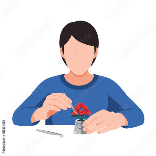 Person meticulously crafting a miniature bouquet of red roses inside a thimble using a pair of small, precise tweezers.