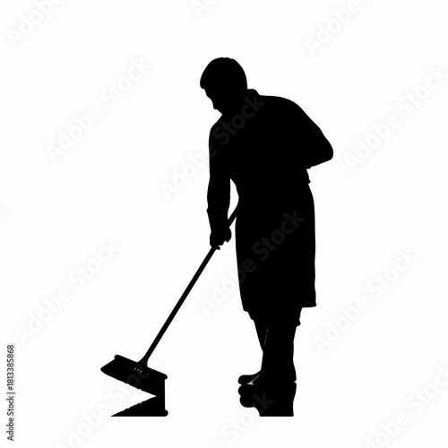 Silhouette of a person cleaning the floor with a squeegee or mop.