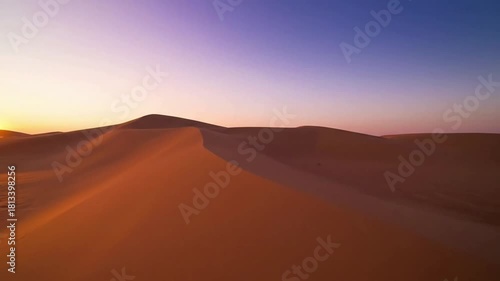 Focus on the intricate, wind sculpted patterns on the sand, revealing delicate lines and abstract compositions of nature. Medium shot with a slight downward tilt, focusing on ground detail.