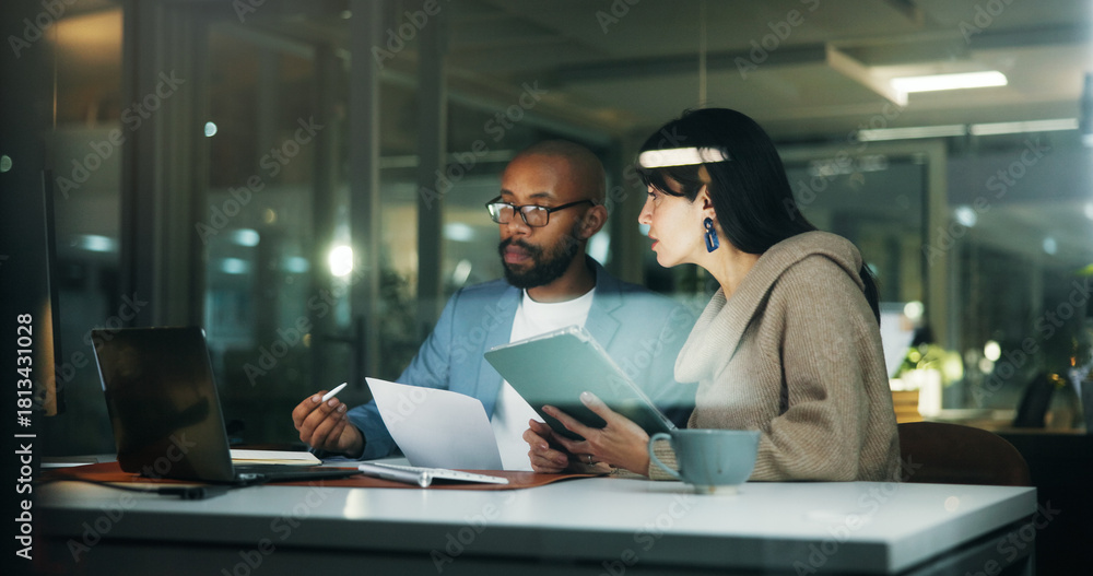 Naklejka premium Business, people and meeting with laptop at night for planning, finance report and review budget. Team, tech and brainstorming with documents, financial evaluation and working late for audit deadline