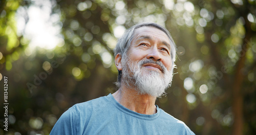 Smile, fitness and thinking with Asian man in nature for runner, confidence and health. Retirement, exercise pride and wellness with senior person for mobility training, low angle and reflection