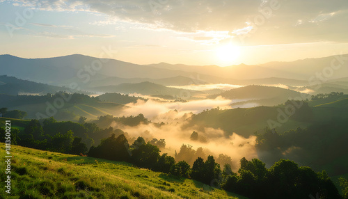 Sunrise over rolling misty mountains with lush green meadows and trees, a breathtaking natural landscape bathed in golden light