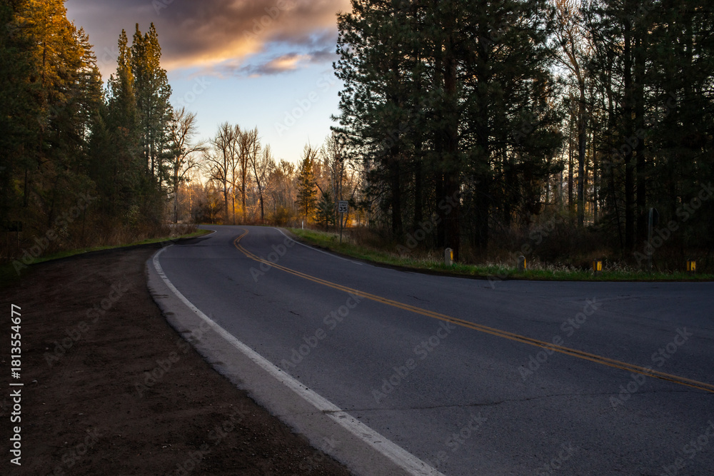 Fototapeta premium A winding country road at sunrise.