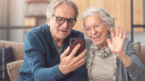Elderly couple using smartphone for video call	