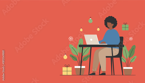 Black woman working on laptop at a desk with holiday decor Remote work and Christmas business concept