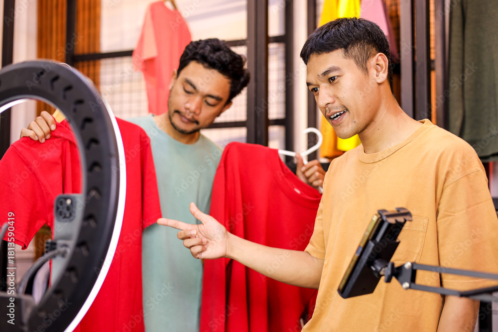 Fototapeta premium Dynamic Duo Streams Live Fashion Review, Shows Off Bright Red Outfits for Online Audience