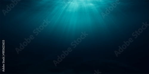 Deep blue ocean light rays burst through the water in an underwater scene