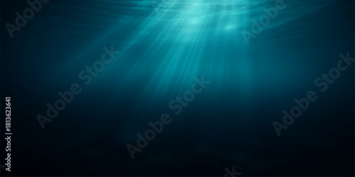 Bright sunlight beams through dark blue ocean water, creating a glowing underwater texture with rays in motion