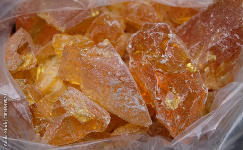 Close up of a piece of natural amber in a plastic bag.