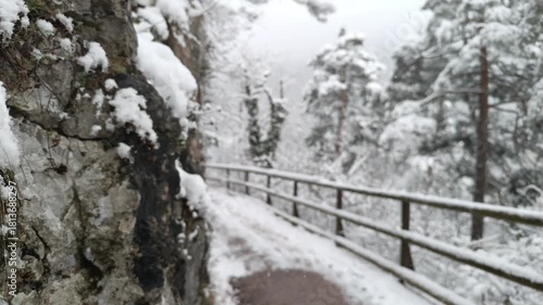 Enjoy a peaceful walk along the snowy path in Kaisertal valley, Tirol, Austria, surrounded by stunning winter scenery and a tranquil atmosphere.