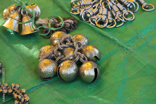 Metal bells for animals are for sale in a traditional street market