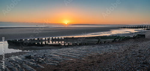 Shipwreck on Broomhill Sands low tide sunset on the east Sussex coast south east England UK