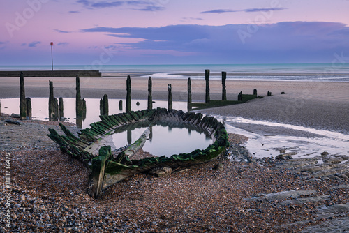 Shipwreck on Broomhill Sands low tide sunset on the east Sussex coast south east England UK