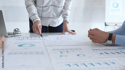 Business people team analyzing financial charts during strategy meeting, professionals discussing data and performance metrics at workplace for decision making success