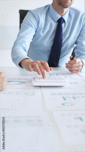 Business professionals analyzing financial charts and graphs during corporate meeting in modern office, focusing on data strategy, growth performance, and market planning
