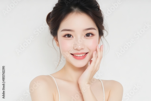 Female Asian Model with Short Hair - Young Beautiful Woman with Hair Bun - Studio Portrait of Asian Beauty for Fashion, Cosmetic, Skincare - Posing on White Background - Smooth Tied Hair