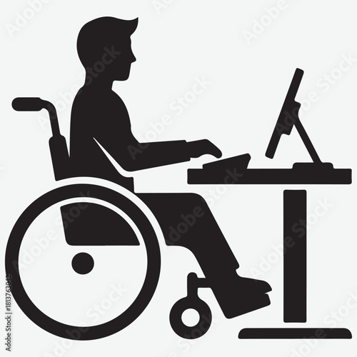 Silhouette of a person in a wheelchair working on a computer