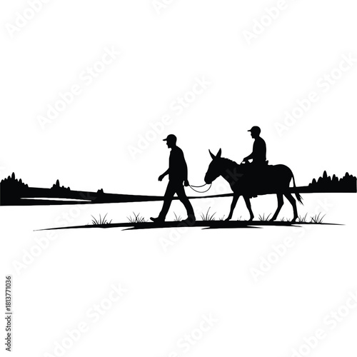 Silhouette of a man walking with a donkey and rider in landscape