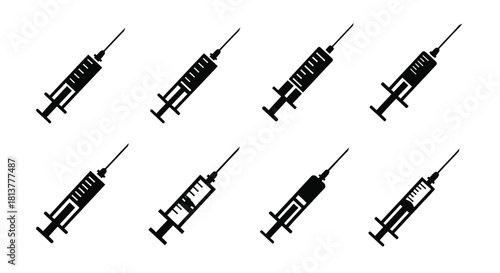 A collection of black and white medical syringes arranged in a grid pattern