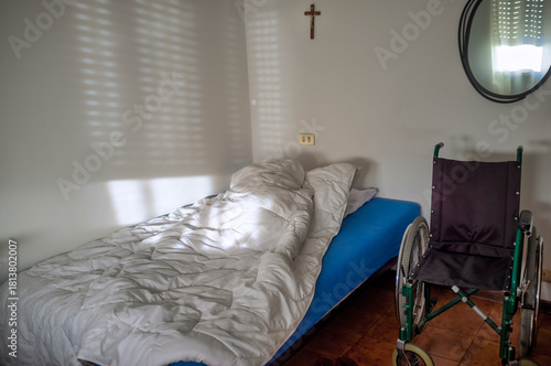Minimalist Bedroom with Empty Wheelchair and Morning Light