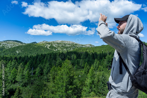 Hiker Enjoying Mountain View on a Sunny Day
