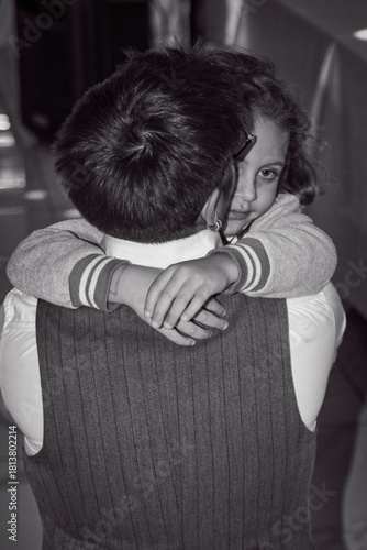 Father Embracing Child at Family Event – Tender Emotional Moment