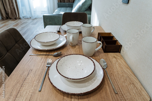 rustic table with warm lighting, homey living room with inviting table and soft illumination, comfortable family setting featuring natural wooden dining area illuminated warmly by sunlight