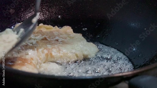 Thai Omelette Cooking Puffing Up in Hot Oil. Crispy Texture Street Food Style