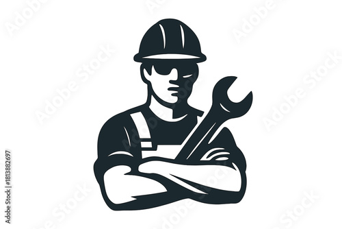 Skilled tradesman wearing safety helmet and overalls holding a large spanner
