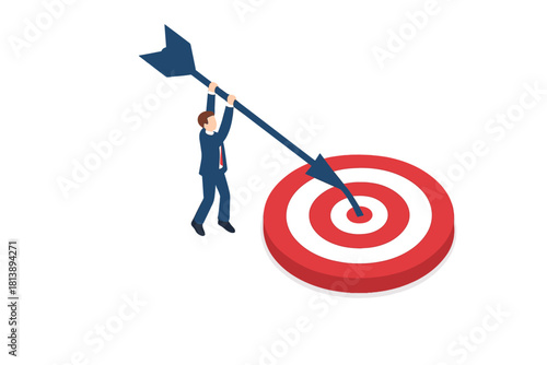 Businessman achieving business goal by hitting the bullseye with a large arrow on a target board