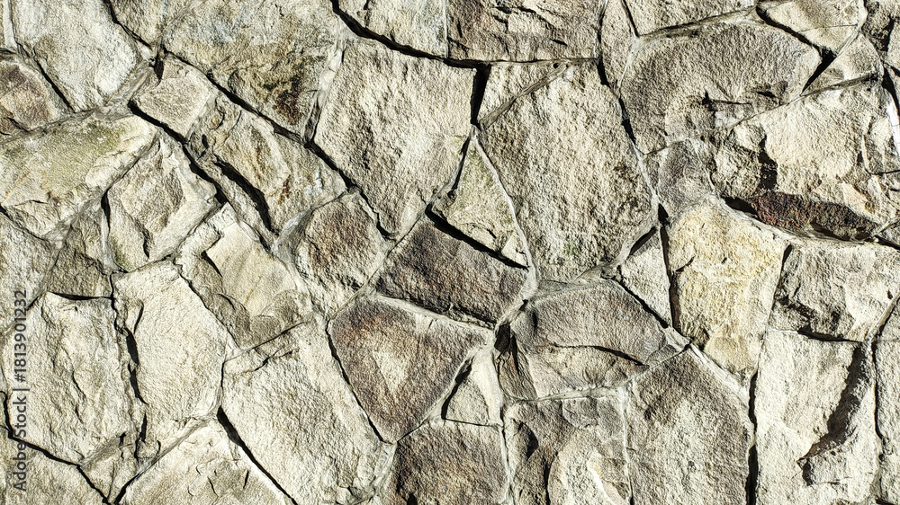 Fototapeta premium Natural stone wall texture, rough gray broken stone