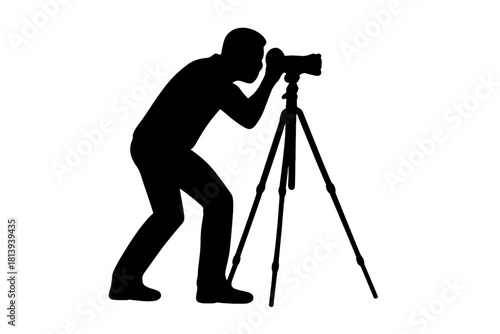 Silhouette of a photographer operating a professional camera on a tripod stand