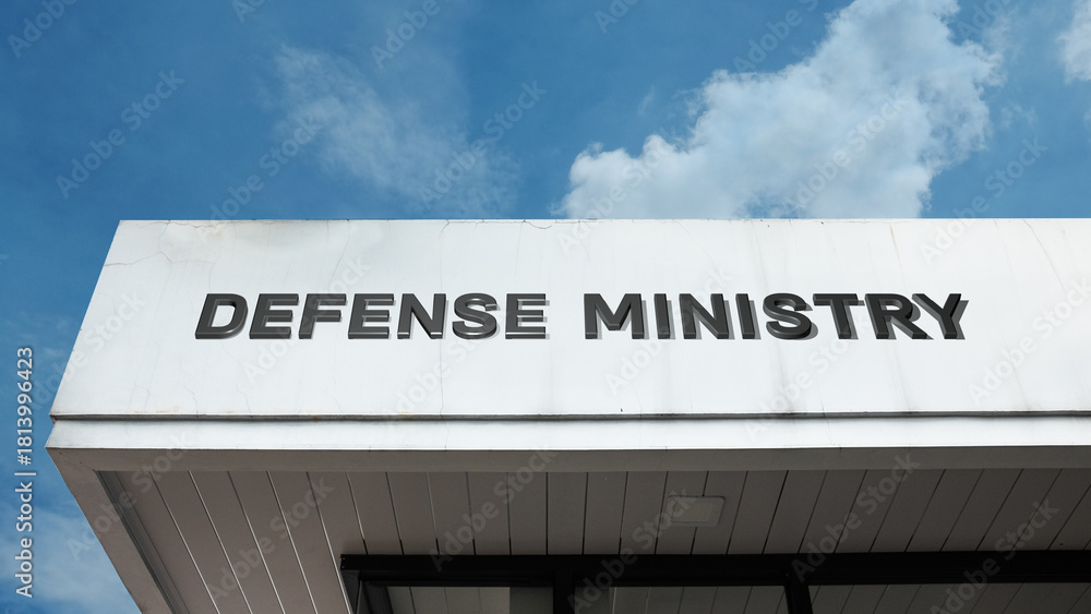Obraz premium Defense Ministry word sign on a building under a clear blue sky, symbolizing military leadership, national security, government administration, defense operations, and strategy
