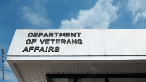 Department of Veterans Affairs word sign on a building under a clear blue sky, representing military veterans' services, healthcare, government policy, and support programs