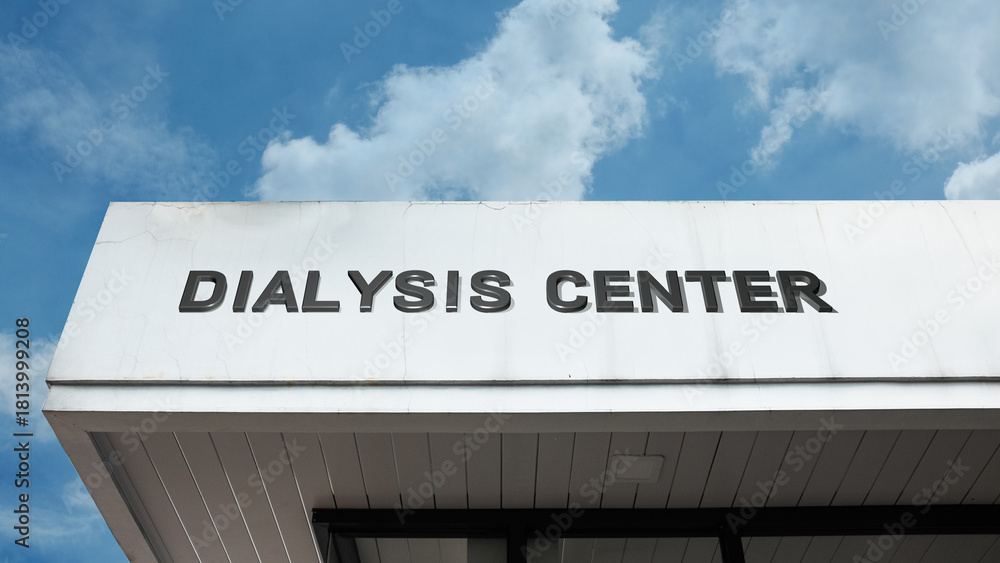 Obraz premium Dialysis Center word sign displayed on a building under a clear blue sky, symbolizing kidney care, medical treatment, and health services