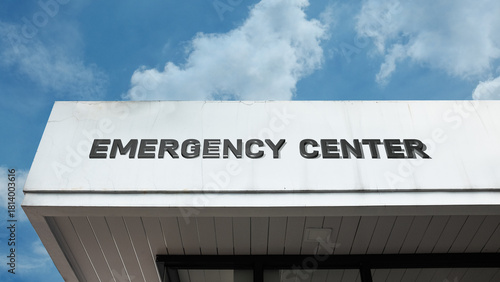 Emergency Center sign displayed on a building against a clear blue sky, symbolizing rapid response, public safety, crisis management, essential services, and immediate aid