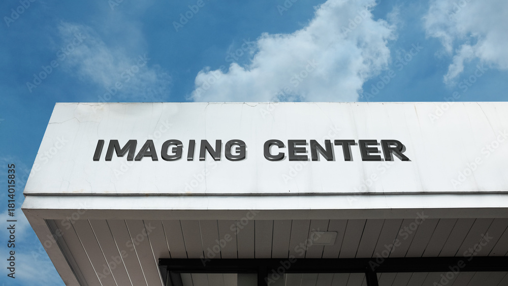 Fototapeta premium Imaging Center sign displayed on a building against a clear blue sky, symbolizing medical diagnostics, radiology services, scanning, and healthcare