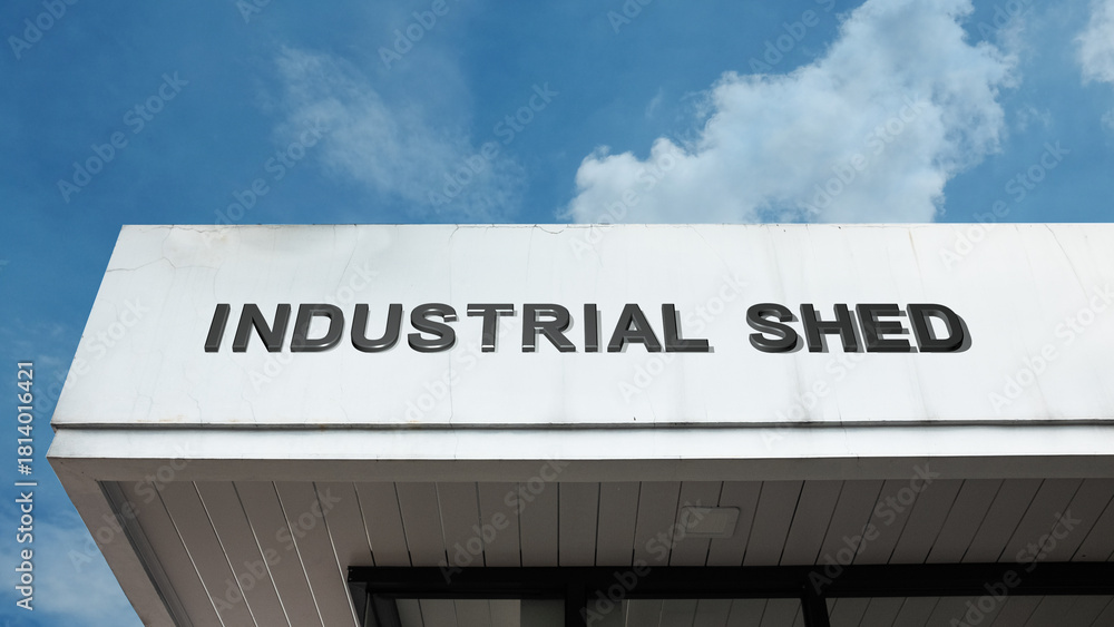 Obraz premium Industrial Shed sign on a building against a clear blue sky, symbolizing manufacturing storage, warehouse facility, commercial utility, and metal