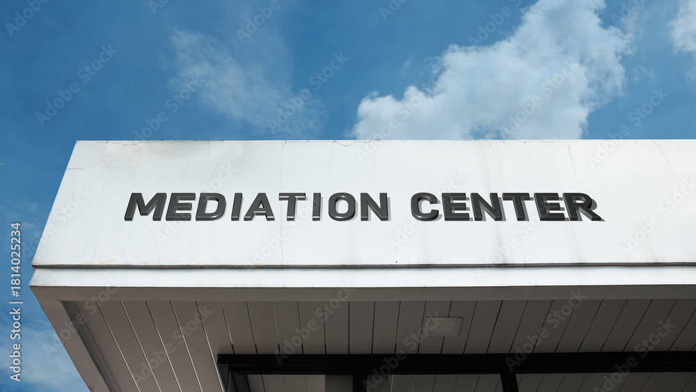 Obraz premium Mediation Center sign on a building against a clear blue sky, symbolizing conflict resolution, legal alternative, professional negotiation, dispute settlement, and peace