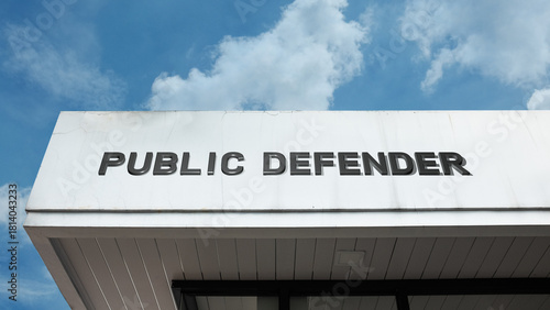 Foto Public Defender word signage on a government or legal building under a blue sky,