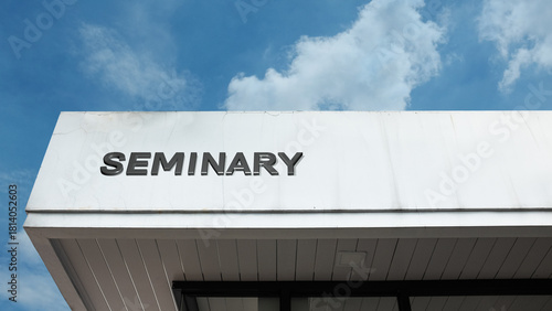 Seminary word signage on a religious or theological building under a blue sky, symbolizing higher education, ministry training, spiritual study, religious leadership, and devotion