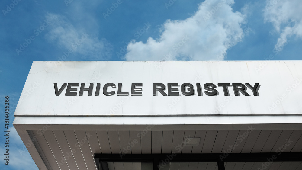 Obraz premium Vehicle Registry word signage on a government building under a blue sky, symbolizing official records, licensing, regulatory compliance, public administration, and transportation law