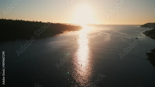 Cinematic Sunrise Scene Rowing Team On Halifax Bay Nova Scotia. Drone Captures The Tranquility Of Early Morning Light As Oars Create Ripples In The Mirror-Like Surface Of The Bay.