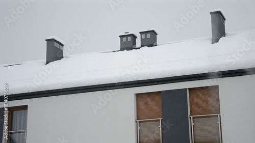 Snow-Covered Roof with Chimneys in Winter
